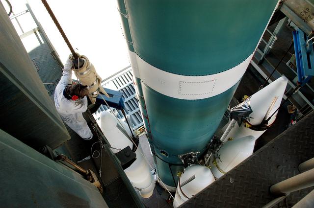 NASA image: KENNEDY SPACE CENTER, FLA. - On the launch tower of Launch Complex 17-B, Cape Canaveral Air Force Station, solid rocket boosters are mated to the Delta II rocket for the Mars Exploration Rover 1 (MER-1) launch June 25.  NASA’s twin Mars Exploration Rovers are designed to study the history of water on Mars. These robotic geologists are equipped with a robotic arm, a drilling tool, three spectrometers, and four pairs of cameras that allow them to have a human-like, 3D view of the terrain. Each rover could travel as far as 100 meters in one day to act as Mars scientists' eyes and hands, exploring an environment where humans can’t yet go.  MER-2 (MER-A) will launch June 5.