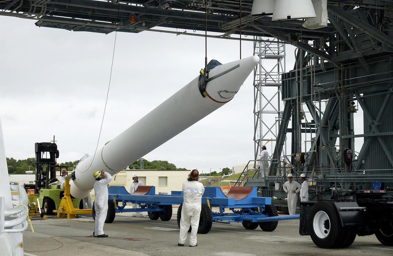 KENNEDY SPACE CENTER, FLA. -  On Launch Complex 17-B, Cape Canaveral Air Force Station, a solid rocket booster is raised off  its transporter to lift it to vertical.  It will be mated to the Delta II rocket for the Mars Exploration Rover 1 (MER-1) launch June 25.  NASA’s twin Mars Exploration Rovers are designed to study the history of water on Mars. These robotic geologists are equipped with a robotic arm, a drilling tool, three spectrometers, and four pairs of cameras that allow them to have a human-like, 3D view of the terrain. Each rover could travel as far as 100 meters in one day to act as Mars scientists' eyes and hands, exploring an environment where humans can’t yet go.  MER-2 (MER-A) will launch June 5.