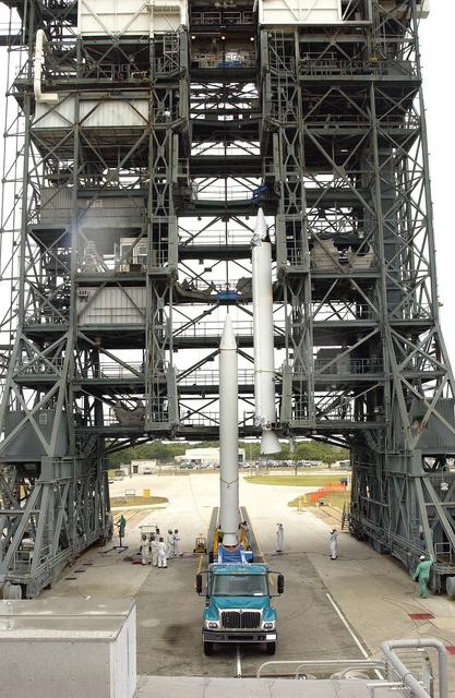 NASA image: KENNEDY SPACE CENTER, FLA. -  Another solid rocket booster is lifted up the launch tower on Launch Complex 17-B, Cape Canaveral Air Force Station.  It will be mated to the Delta II rocket for the Mars Exploration Rover 1 (MER-1) launch June 25.  NASA’s twin Mars Exploration Rovers are designed to study the history of water on Mars. These robotic geologists are equipped with a robotic arm, a drilling tool, three spectrometers, and four pairs of cameras that allow them to have a human-like, 3D view of the terrain. Each rover could travel as far as 100 meters in one day to act as Mars scientists' eyes and hands, exploring an environment where humans can’t yet go.  MER-2 (MER-A) will launch June 5.