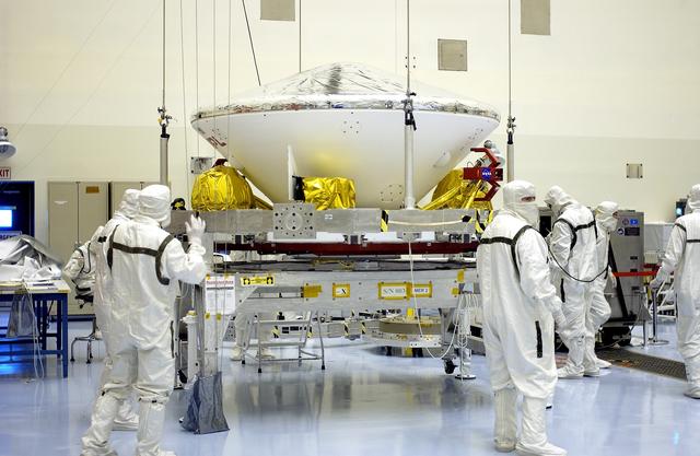 NASA image: KENNEDY SPACE CENTER, FLA. -  In the Payload Hazardous Servicing Facility, workers prepare to mate the Mars Exploration Rover-2 (MER-2) to the third stage of a Delta II rocket for launch on June 5.  NASA’s twin Mars Exploration Rovers are designed to study the history of water on Mars. These robotic geologists are equipped with a robotic arm, a drilling tool, three spectrometers, and four pairs of cameras that allow them to have a human-like, 3D view of the terrain. Each rover could travel as far as 100 meters in one day to act as Mars scientists' eyes and hands, exploring an environment where humans can’t yet go.  MER-1 (MER-B) will launch June 25.