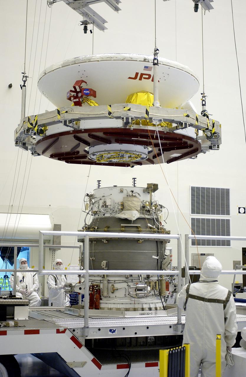 KENNEDY SPACE CENTER, FLA. -  In the Payload Hazardous Servicing Facility, workers prepare to mate the Mars Exploration Rover-2 (MER-2) to the third stage of a Delta II rocket for launch on June 5.  NASA’s twin Mars Exploration Rovers are designed to study the history of water on Mars. These robotic geologists are equipped with a robotic arm, a drilling tool, three spectrometers, and four pairs of cameras that allow them to have a human-like, 3D view of the terrain. Each rover could travel as far as 100 meters in one day to act as Mars scientists' eyes and hands, exploring an environment where humans can’t yet go.  MER-1 (MER-B) will launch June 25.