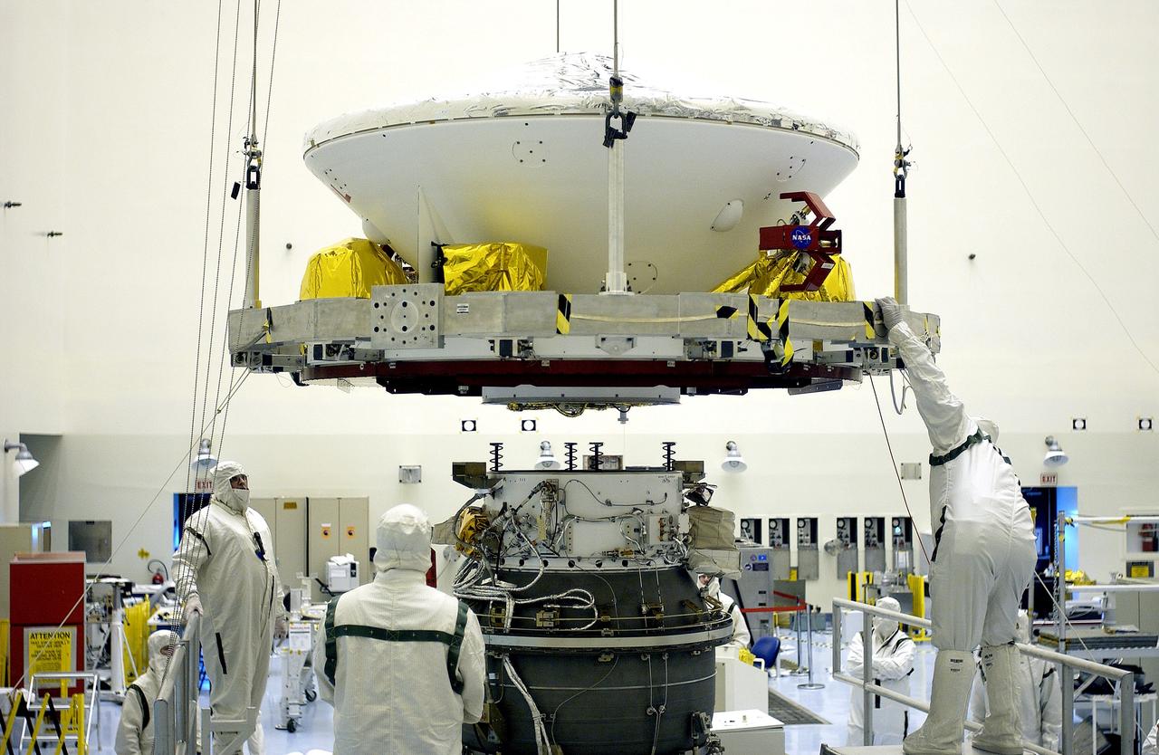 KENNEDY SPACE CENTER, FLA. -  In the Payload Hazardous Servicing Facility, workers prepare to mate the Mars Exploration Rover-2 (MER-2) to the third stage of a Delta II rocket for launch on June 5.  NASA’s twin Mars Exploration Rovers are designed to study the history of water on Mars. These robotic geologists are equipped with a robotic arm, a drilling tool, three spectrometers, and four pairs of cameras that allow them to have a human-like, 3D view of the terrain. Each rover could travel as far as 100 meters in one day to act as Mars scientists' eyes and hands, exploring an environment where humans can’t yet go.  MER-1 (MER-B) will launch June 25.