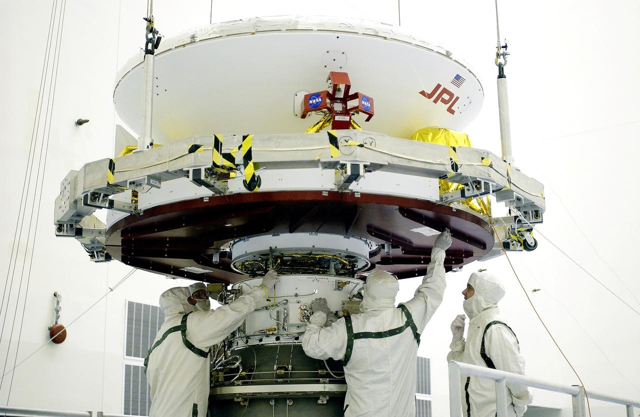 KENNEDY SPACE CENTER, FLA. -  In the Payload Hazardous Servicing Facility, workers mate the Mars Exploration Rover-2 (MER-2) to the third stage of a Delta II rocket for launch on June 5.  NASA’s twin Mars Exploration Rovers are designed to study the history of water on Mars. These robotic geologists are equipped with a robotic arm, a drilling tool, three spectrometers, and four pairs of cameras that allow them to have a human-like, 3D view of the terrain. Each rover could travel as far as 100 meters in one day to act as Mars scientists' eyes and hands, exploring an environment where humans can’t yet go.  MER-1 (MER-B) will launch June 25.