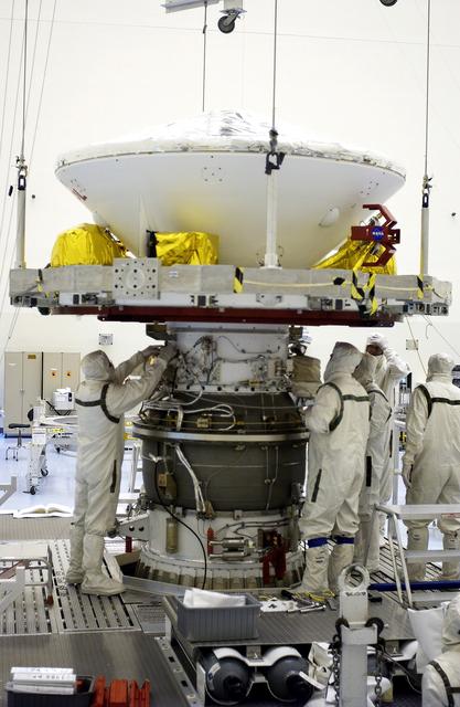 NASA image: KENNEDY SPACE CENTER, FLA. -  In the Payload Hazardous Servicing Facility, workers mate the Mars Exploration Rover-2 (MER-2) to the third stage of a Delta II rocket for launch on June 5.  NASA’s twin Mars Exploration Rovers are designed to study the history of water on Mars. These robotic geologists are equipped with a robotic arm, a drilling tool, three spectrometers, and four pairs of cameras that allow them to have a human-like, 3D view of the terrain. Each rover could travel as far as 100 meters in one day to act as Mars scientists' eyes and hands, exploring an environment where humans can’t yet go.  MER-1 (MER-B) will launch June 25.