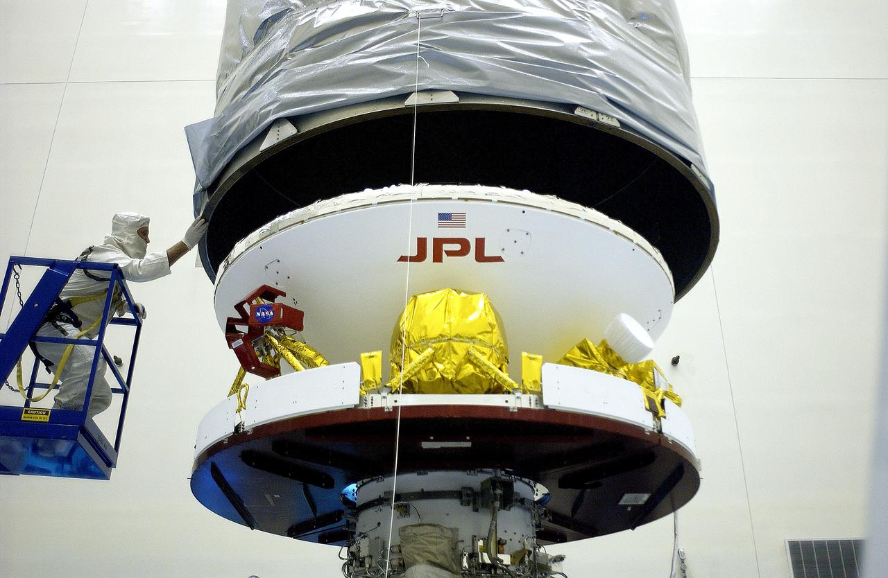 KENNEDY SPACE CENTER, FLA. -  In the Payload Hazardous Servicing Facility, the Mars Exploration Rover 2 (MER-2) is being encapsulated for transfer to Launch Complex 17-A, Cape Canaveral Air Force Station.  MER-2 is one of NASA's twin Mars Exploration Rovers designed to study the history of water on Mars. These robotic geologists are equipped with a robotic arm, a drilling tool, three spectrometers, and four pairs of cameras that allow them to have a human-like, 3D view of the terrain. Each rover could travel as far as 100 meters in one day to act as Mars scientists' eyes and hands, exploring an environment where humans can't yet go.  MER-2 is scheduled to launch no earlier than June 8 as MER-A aboard a Delta II rocket.