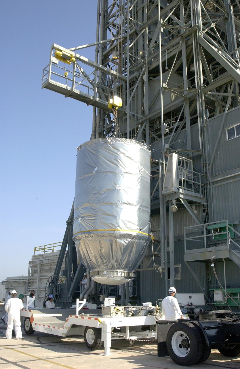 KENNEDY SPACE CENTER, FLA. - On Launch Pad 17-A, Cape Canaveral Air Force Station, the Mars Exploration Rover 2 (MER-2), inside the transport canister, is lifted off the transporter and into the launch tower where it will be mated to the Delta II rocket for launch. MER-2 is one of NASA's twin Mars Exploration Rovers designed to study the history of water on Mars. These robotic geologists are equipped with a robotic arm, a drilling tool, three spectrometers, and four pairs of cameras that allow them to have a human-like, 3D view of the terrain. Each rover could travel as far as 100 meters in one day to act as Mars scientists' eyes and hands, exploring an environment where humans can't yet go. MER-2 is scheduled to launch no earlier than June 8 as MER-A.