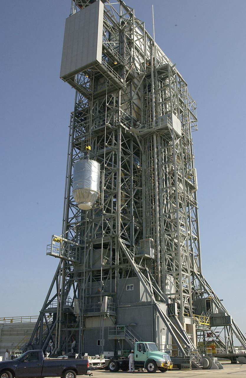 KENNEDY SPACE CENTER, FLA. - On Launch Pad 17-A, Cape Canaveral Air Force Station, the Mars Exploration Rover 2 (MER-2), inside the transport canister, is lifted up the launch tower where it will be mated to the Delta II rocket for launch.  MER-2 is one of NASA's twin Mars Exploration Rovers designed to study the history of water on Mars. These robotic geologists are equipped with a robotic arm, a drilling tool, three spectrometers, and four pairs of cameras that allow them to have a human-like, 3D view of the terrain. Each rover could travel as far as 100 meters in one day to act as Mars scientists' eyes and hands, exploring an environment where humans can't yet go.  MER-2 is scheduled to launch no earlier than June 8 as MER-A.