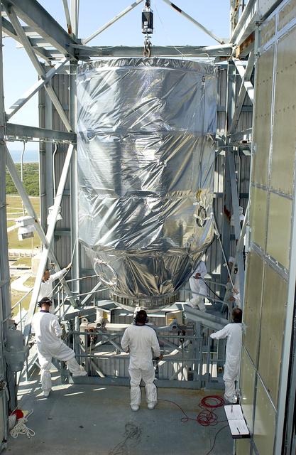 NASA image: KENNEDY SPACE CENTER, FLA. - On Launch Pad 17-A, Cape Canaveral Air Force Station, the Mars Exploration Rover 2 (MER-2), inside the transport canister, is moved toward the platform in the launch tower.  MER-2 will be mated to the Delta II rocket for launch.  MER-2 is one of NASA's twin Mars Exploration Rovers designed to study the history of water on Mars. These robotic geologists are equipped with a robotic arm, a drilling tool, three spectrometers, and four pairs of cameras that allow them to have a human-like, 3D view of the terrain. Each rover could travel as far as 100 meters in one day to act as Mars scientists' eyes and hands, exploring an environment where humans can't yet go.  MER-2 is scheduled to launch no earlier than June 8 as MER-A.