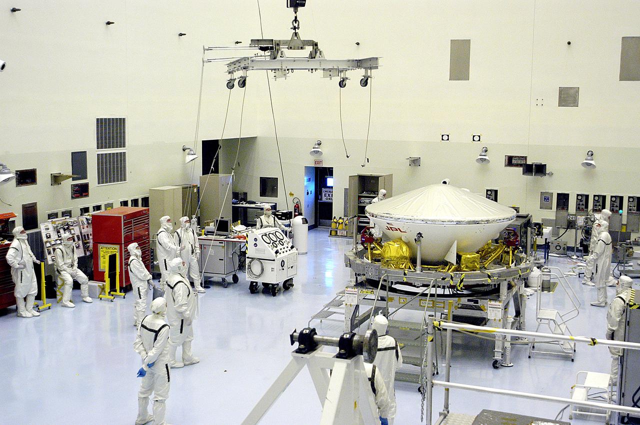 KENNEDY SPACE CENTER, FLA. - In the Payload Hazardous Servicing Facility, workers prepare to lift the Mars Exploration Rover-1 (MER-B) onto a spin table during preflight processing of the spacecraft.  The rover is scheduled to launch aboard a Delta II rocket on June 25.  NASA’s twin Mars Exploration Rovers are designed to study the history of water on Mars. These robotic geologists are equipped with a robotic arm, a drilling tool, three spectrometers, and four pairs of cameras that allow them to have a human-like, 3D view of the terrain. Each rover could travel as far as 100 meters in one day to act as Mars scientists' eyes and hands, exploring an environment where humans are not yet able to go. The launch of MER-2 (MER-A) is tentatively set for June 8.