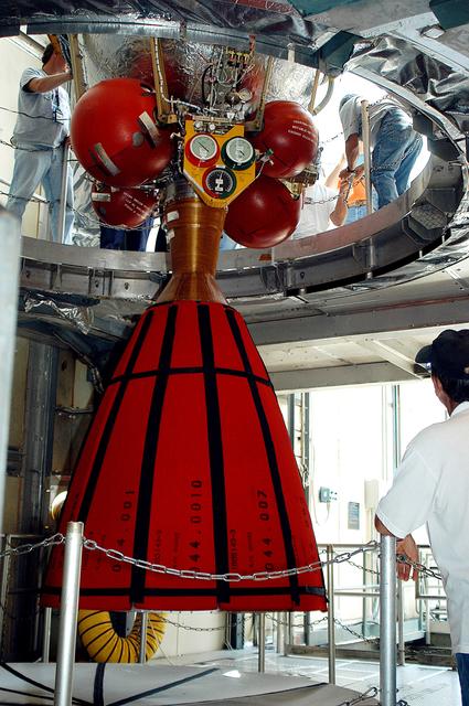 NASA image: KENNEDY SPACE CENTER, FLA. - The second stage of a Delta II rocket is lowered into positioned above a first stage at Pad 17-B, Cape Canaveral Air Force Station. Next, it will be mated to the first stage in preparation for the launch of the Mars Exploration Rover-1 (MER-B) on June 25.  NASA’s twin Mars Exploration Rovers are designed to study the history of water on Mars. These robotic geologists are equipped with a robotic arm, a drilling tool, three spectrometers, and four pairs of cameras that allow them to have a human-like, 3D view of the terrain. Each rover could travel as far as 100 meters in one day to act as Mars scientists' eyes and hands, exploring an environment where humans are not yet able to go. The launch of MER-2 (MER-A) is tentatively set for June 8.