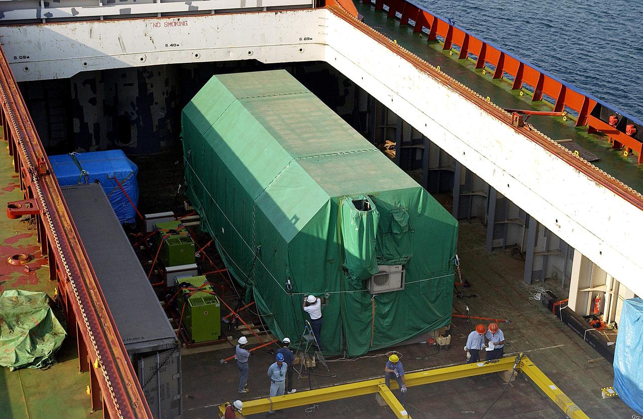 KENNEDY SPACE CENTER, FLA. - The JEM Pressurized Module is seen in the hold of the ship that carried it from Japan.  The National Space Development Agency of Japan (NASDA) built the laboratory at the Tsukuba Space Center near Tokyo.  The Pressurized Module is the first element of the JEM, Japan’s primary contribution to the space station, to be delivered to KSC. It will enhance the unique research capabilities of the orbiting complex by providing an additional shirt-sleeve environment for astronauts to conduct science experiments. The JEM also includes two logistics modules, an exposed pallet for space environment experiments and a robotic manipulator system that are still under construction in Japan. The various JEM components will be assembled in space over the course of three space shuttle missions.