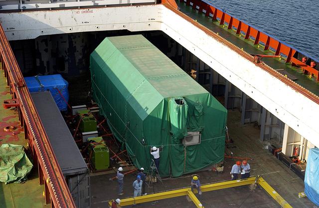 NASA image: KENNEDY SPACE CENTER, FLA. - The JEM Pressurized Module is seen in the hold of the ship that carried it from Japan.  The National Space Development Agency of Japan (NASDA) built the laboratory at the Tsukuba Space Center near Tokyo.  The Pressurized Module is the first element of the JEM, Japan’s primary contribution to the space station, to be delivered to KSC. It will enhance the unique research capabilities of the orbiting complex by providing an additional shirt-sleeve environment for astronauts to conduct science experiments. The JEM also includes two logistics modules, an exposed pallet for space environment experiments and a robotic manipulator system that are still under construction in Japan. The various JEM components will be assembled in space over the course of three space shuttle missions.