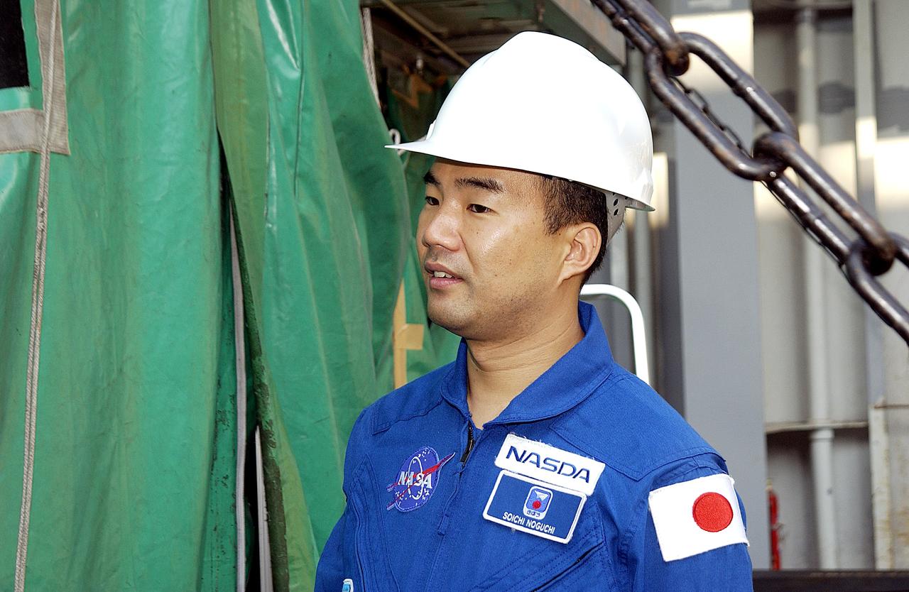 KENNEDY SPACE CENTER, FLA. - Astronaut Soichi Noguchi, with the National Space Development Agency of Japan (NASDA), looks at the Japanese Experiment Module after its arrival at Port Canaveral, Fla.   Built by the Tsukuba Space Center near Tokyo, the pressurized module is the first element of the JEM, Japan’s primary contribution to the space station, to be delivered to KSC. It will enhance the unique research capabilities of the orbiting complex by providing an additional shirt-sleeve environment for astronauts to conduct science experiments. The JEM also includes two logistics modules, an exposed pallet for space environment experiments and a robotic manipulator system that are still under construction in Japan. The various JEM components will be assembled in space over the course of three space shuttle missions. .