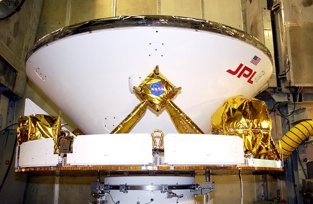 NASA image: KENNEDY SPACE CENTER, FLA. - At Launch Complex 17-A, Cape Canaveral Air Force Station, the Mars Exploration Rover 2 (MER-2) is ready for installation of the fairing that will enclose it for launch.  MER-2 is one of NASA's twin Mars Exploration Rovers designed to study the history of water on Mars. These robotic geologists are equipped with a robotic arm, a drilling tool, three spectrometers, and four pairs of cameras that allow them to have a human-like, 3D view of the terrain. Each rover could travel as far as 100 meters in one day to act as Mars scientists' eyes and hands, exploring an environment where humans can't yet go.  MER-2 is scheduled to launch no earlier than June 8 as MER-A, with two launch opportunities each day during the launch period that closes on June 19.