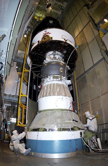 NASA image: KENNEDY SPACE CENTER, FLA. - At Launch Complex 17-A, Cape Canaveral Air Force Station, the first half of the fairing for the Mars Exploration Rover 2 (MER-2) is installed around the Mars Exploration Rover 2 (MER-2).  MER-2 is one of NASA's twin Mars Exploration Rovers designed to study the history of water on Mars. These robotic geologists are equipped with a robotic arm, a drilling tool, three spectrometers, and four pairs of cameras that allow them to have a human-like, 3D view of the terrain. Each rover could travel as far as 100 meters in one day to act as Mars scientists' eyes and hands, exploring an environment where humans can't yet go.  MER-2 is scheduled to launch no earlier than June 8 as MER-A, with two launch opportunities each day during the launch period that closes on June 19.