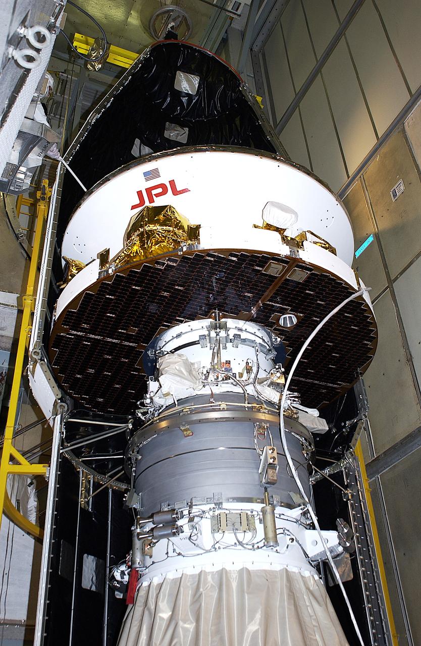 KENNEDY SPACE CENTER, FLA. - At Launch Complex 17-A, Cape Canaveral Air Force Station, the first half of the fairing for the Mars Exploration Rover 2 (MER-2) is installed around the Mars Exploration Rover 2 (MER-2).  MER-2 is one of NASA's twin Mars Exploration Rovers designed to study the history of water on Mars. These robotic geologists are equipped with a robotic arm, a drilling tool, three spectrometers, and four pairs of cameras that allow them to have a human-like, 3D view of the terrain. Each rover could travel as far as 100 meters in one day to act as Mars scientists' eyes and hands, exploring an environment where humans can't yet go.  MER-2 is scheduled to launch no earlier than June 8 as MER-A, with two launch opportunities each day during the launch period that closes on June 19.