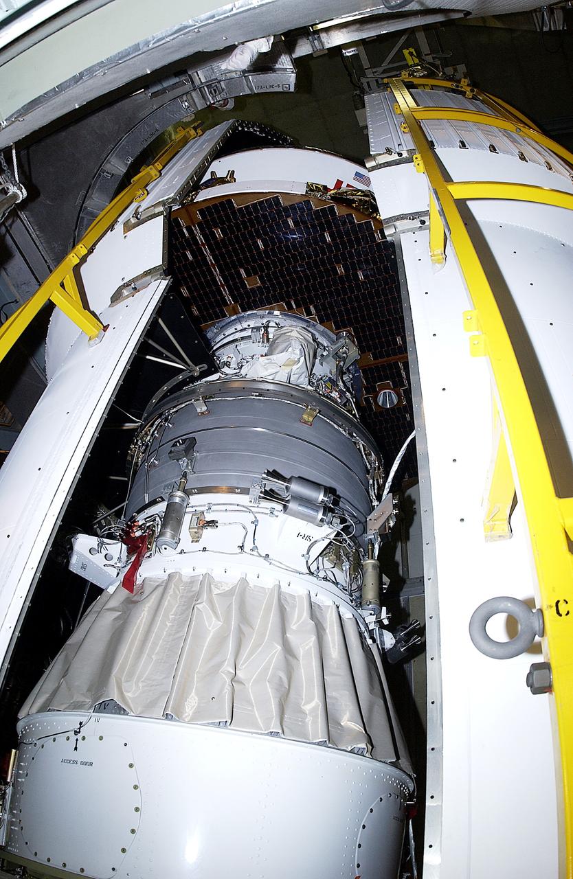 KENNEDY SPACE CENTER, FLA. - The second half of the fairing closes in around the Mars Exploration Rover 2 (MER-2) on Launch Complex 17-A, Cape Canaveral Air Force Station.  MER-2 is one of NASA's twin Mars Exploration Rovers designed to study the history of water on Mars. These robotic geologists are equipped with a robotic arm, a drilling tool, three spectrometers, and four pairs of cameras that allow them to have a human-like, 3D view of the terrain. Each rover could travel as far as 100 meters in one day to act as Mars scientists' eyes and hands, exploring an environment where humans can't yet go.  MER-2 is scheduled to launch no earlier than June 8 as MER-A, with two launch opportunities each day during the launch period that closes on June 19.