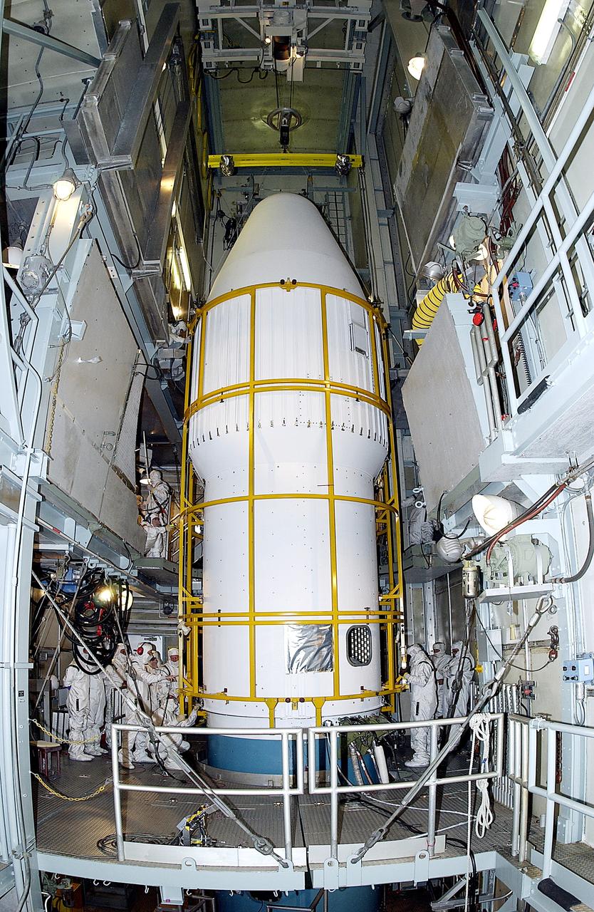 KENNEDY SPACE CENTER, FLA. -  The two halves of the fairing come together around the Mars Exploration Rover 2 (MER-2) on Launch Complex 17-A, Cape Canaveral Air Force Station.  MER-2 is one of NASA's twin Mars Exploration Rovers designed to study the history of water on Mars. These robotic geologists are equipped with a robotic arm, a drilling tool, three spectrometers, and four pairs of cameras that allow them to have a human-like, 3D view of the terrain. Each rover could travel as far as 100 meters in one day to act as Mars scientists' eyes and hands, exploring an environment where humans can't yet go.  MER-2 is scheduled to launch no earlier than June 8, 2003, as MER-A, with two launch opportunities each day during the launch period that closes on June 19.