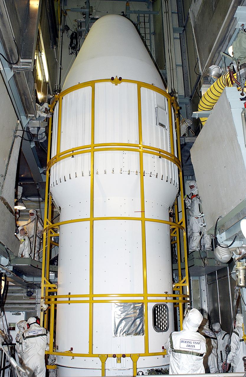 KENNEDY SPACE CENTER, FLA. - The installation of the fairing around the Mars Exploration Rover 2 (MER-2) is complete on Launch Complex 17-A, Cape Canaveral Air Force Station.  MER-2 is one of NASA's twin Mars Exploration Rovers designed to study the history of water on Mars. These robotic geologists are equipped with a robotic arm, a drilling tool, three spectrometers, and four pairs of cameras that allow them to have a human-like, 3D view of the terrain. Each rover could travel as far as 100 meters in one day to act as Mars scientists' eyes and hands, exploring an environment where humans can't yet go.  MER-2 is scheduled to launch no earlier than June 8 as MER-A, with two launch opportunities each day during the launch period that closes on June 19.