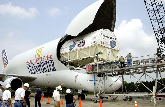 NASA image: KENNEDY SPACE CENTER, FLA. - The Italian-built module, U.S. Node 2, for the International Space Station is offloaded from a Beluga aircraft at the Shuttle Landing Facility. The second of three Station connecting modules, Node 2 attaches to the end of the U.S. Lab and provides attach locations for the Japanese laboratory, European laboratory, the Centrifuge Accommodation Module and, later, Multipurpose Logistics Modules. It will provide the primary docking location for the Shuttle when a pressurized mating adapter is attached to Node 2.  Installation of the module will complete  the U.S. Core of the ISS.  Node 2 is the designated payload for mission STS-120.  No orbiter or launch date has been determined yet.
