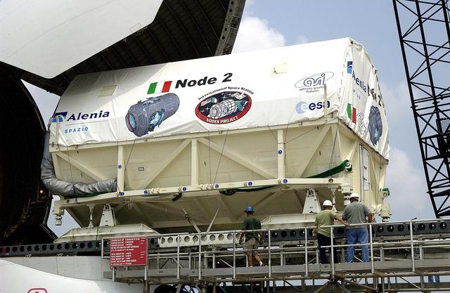 NASA image: KENNEDY SPACE CENTER, FLA. - The Italian-built module, U.S. Node 2, for the International Space Station is offloaded from a Beluga aircraft at the Shuttle Landing Facility. The second of three Station connecting modules, Node 2 attaches to the end of the U.S. Lab and provides attach locations for the Japanese laboratory, European laboratory, the Centrifuge Accommodation Module and, later, Multipurpose Logistics Modules. It will provide the primary docking location for the Shuttle when a pressurized mating adapter is attached to Node 2.  Installation of the module will complete  the U.S. Core of the ISS.  Node 2 is the designated payload for mission STS-120.  No orbiter or launch date has been determined yet.