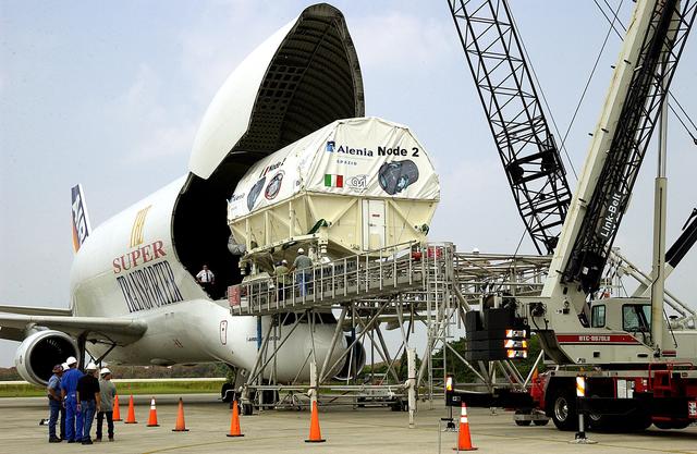 NASA image: KENNEDY SPACE CENTER, FLA. - The Italian-built module, U.S. Node 2, for the International Space Station after offloading from a Beluga aircraft at the Shuttle Landing Facility. The second of three Station connecting modules, Node 2 attaches to the end of the U.S. Lab and provides attach locations for the Japanese laboratory, European laboratory, the Centrifuge Accommodation Module and, later, Multipurpose Logistics Modules. It will provide the primary docking location for the Shuttle when a pressurized mating adapter is attached to Node 2.  Installation of the module will complete  the U.S. Core of the ISS.  Node 2 is the designated payload for mission STS-120.  No orbiter or launch date has been determined yet.