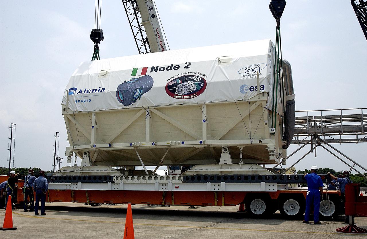 KENNEDY SPACE CENTER, FLA. -  The Italian-built module, U.S. Node 2, is lowered onto a transporter after its arrival at the Shuttle Landing Facility.  It will be taken to the Space Station Processing Facility.  The second of three connecting modules on the International Space Station, Node 2 attaches to the end of the U.S. Lab and provides attach locations for the Japanese laboratory, European laboratory, the Centrifuge Accommodation Module and, later, Multipurpose Logistics Modules. It will provide the primary docking location for the Shuttle when a pressurized mating adapter is attached to Node 2.  Installation of the module will complete  the U.S. Core of the ISS.  Node 2 is the designated payload for mission STS-120.  No orbiter or launch date has been determined yet.