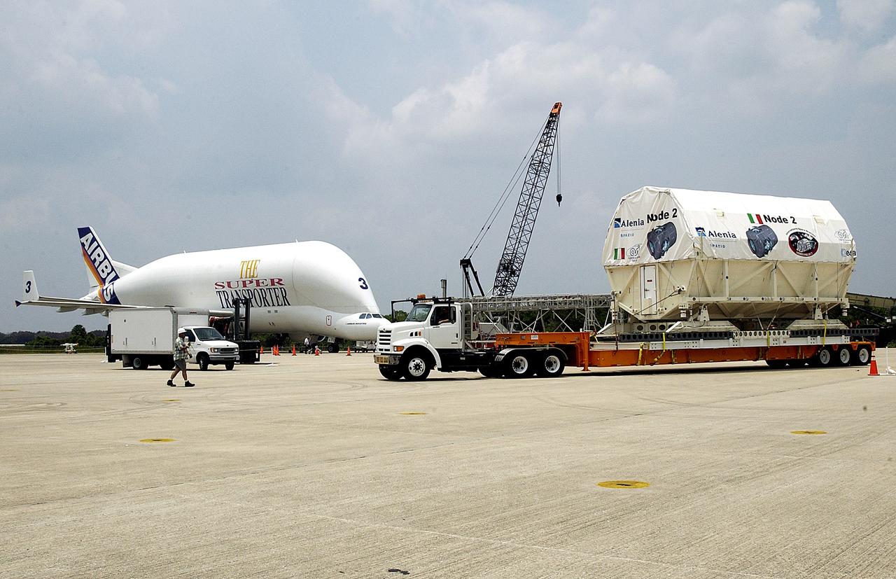 KENNEDY SPACE CENTER, FLA. -  The Italian-built module, U.S. Node 2, begins its transfer from  the Shuttle Landing Facility to the Space Station Processing Facility.  Inthe background, left, is the Beluga aircraft that brought it to KSC.  The second of three connecting modules on the International Space Station, Node 2 attaches to the end of the U.S. Lab and provides attach locations for the Japanese laboratory, European laboratory, the Centrifuge Accommodation Module and, later, Multipurpose Logistics Modules. It will provide the primary docking location for the Shuttle when a pressurized mating adapter is attached to Node 2.  Installation of the module will complete  the U.S. Core of the ISS.  Node 2 is the designated payload for mission STS-120.  No orbiter or launch date has been determined yet.