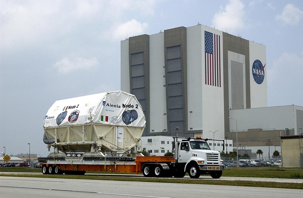 KENNEDY SPACE CENTER, FLA. -  The Italian-built module, U.S. Node 2, moves past the Vehicle Assembly Building as it is transferred to the Space Station Processing Facility. The second of three connecting modules on the International Space Station, Node 2 attaches to the end of the U.S. Lab and provides attach locations for the Japanese laboratory, European laboratory, the Centrifuge Accommodation Module and, later, Multipurpose Logistics Modules. It will provide the primary docking location for the Shuttle when a pressurized mating adapter is attached to Node 2.  Installation of the module will complete  the U.S. Core of the ISS.  Node 2 is the designated payload for mission STS-120.  No orbiter or launch date has been determined yet.