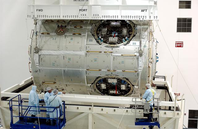 NASA image: KENNEDY SPACE CENTER, FLA. - An overhead crane in the Space Station Processing Facility lifts the U.S. Node 2 out of its shipping container.  The node will be moved to a workstand.  The second of three connecting modules on the International Space Station, the Italian-built Node 2 attaches to the end of the U.S. Lab and provides attach locations for the Japanese laboratory, European laboratory, the Centrifuge Accommodation Module and, later, Multipurpose Logistics Modules. It will provide the primary docking location for the Shuttle when a pressurized mating adapter is attached to Node 2.  Installation of the module will complete  the U.S. Core of the ISS.  Node 2 is the designated payload for mission STS-120.  No orbiter or launch date has been determined yet.