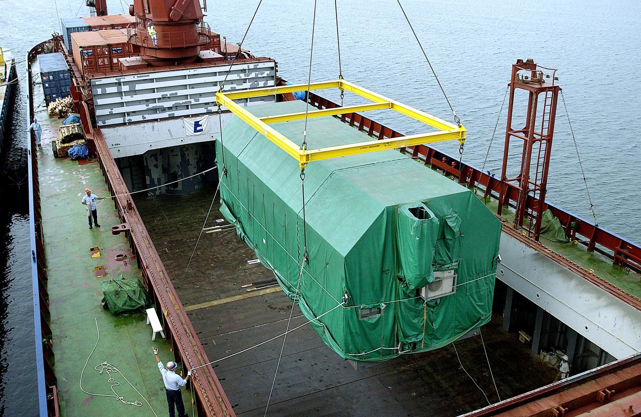 KENNEDY SPACE CENTER, FLA. - At Port Canaveral, the Pressurized Module of the Japanese Experiment Module (JEM) is lifted out of the ship’s cargo hold.  The container transport ship carrying JEM departed May 2 from Yokohama Harbor in Japan for the voyage to the United States. The National Space Development Agency of Japan (NASDA) developed the laboratory at the Tsukuba Space Center near Tokyo. The Pressurized Module is the first element of the JEM, named "Kibo" (Hope), to be delivered to KSC. The JEM is Japan's primary contribution to the Station. It will enhance the unique research capabilities of the orbiting complex by providing an additional environment for astronauts to conduct science experiments.  The JEM also includes an exposed facility (platform) for space environment experiments, a robotic manipulator system, and two logistics modules. The various JEM components will be  assembled in space over the course of three Shuttle missions.