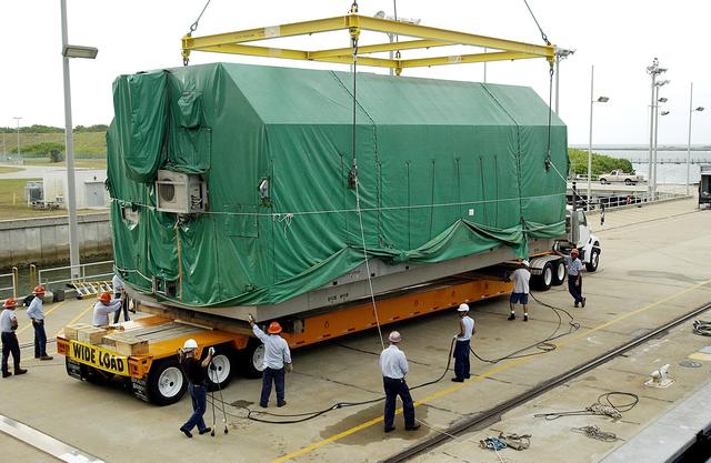 NASA image: KENNEDY SPACE CENTER, FLA. - At Port Canaveral, the Pressurized Module of the Japanese Experiment Module (JEM) is lowered onto a truck bed for transfer to KSC’s Space Station Processing Facility.  The container transport ship carrying JEM departed May 2 from Yokohama Harbor in Japan for the voyage to the United States. The National Space Development Agency of Japan (NASDA) developed the laboratory at the Tsukuba Space Center near Tokyo. The Pressurized Module is the first element of the JEM, named "Kibo" (Hope), to be delivered to KSC. The JEM is Japan's primary contribution to the Station. It will enhance the unique research capabilities of the orbiting complex by providing an additional environment for astronauts to conduct science experiments.  The JEM also includes an exposed facility (platform) for space environment experiments, a robotic manipulator system, and two logistics modules. The various JEM components will be  assembled in space over the course of three Shuttle missions.