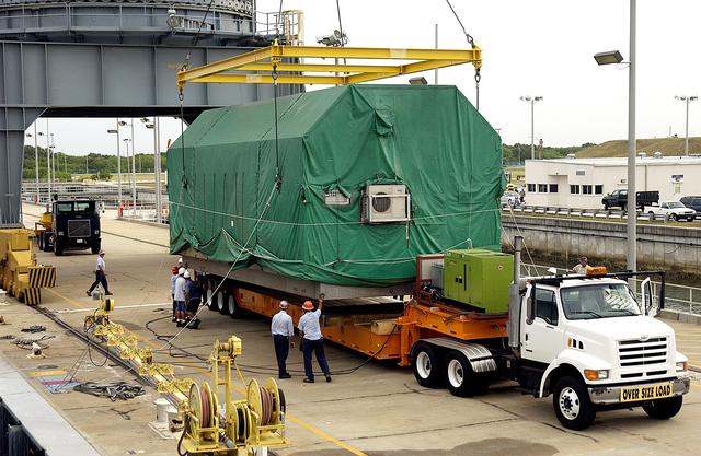 NASA image: KENNEDY SPACE CENTER, FLA. - At Port Canaveral, the Pressurized Module of the Japanese Experiment Module (JEM) is settled on a truck bed for transfer to KSC’s Space Station Processing Facility.  The container transport ship carrying JEM departed May 2 from Yokohama Harbor in Japan for the voyage to the United States. The National Space Development Agency of Japan (NASDA) developed the laboratory at the Tsukuba Space Center near Tokyo. The Pressurized Module is the first element of the JEM, named "Kibo" (Hope), to be delivered to KSC. The JEM is Japan's primary contribution to the Station. It will enhance the unique research capabilities of the orbiting complex by providing an additional environment for astronauts to conduct science experiments.  The JEM also includes an exposed facility (platform) for space environment experiments, a robotic manipulator system, and two logistics modules. The various JEM components will be  assembled in space over the course of three Shuttle missions.