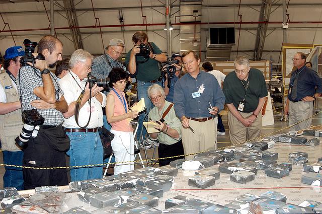 KENNEDY SPACE CENTER, FLA. -  In the Columbia Debris Hangar,  Shuttle Launch Director Mike Leinbach  (center) points to some of the tiles recovered from the orbiter as he explains to the media about activities that have taken place since the Columbia accident on Feb. 1, 2003.  STS-107 debris recovery and reconstruction operations are winding down.  To date, nearly 84,000 pieces of debris have been recovered and sent to KSC. That represents about 38 percent of the dry weight of Columbia, equaling almost 85,000 pounds.