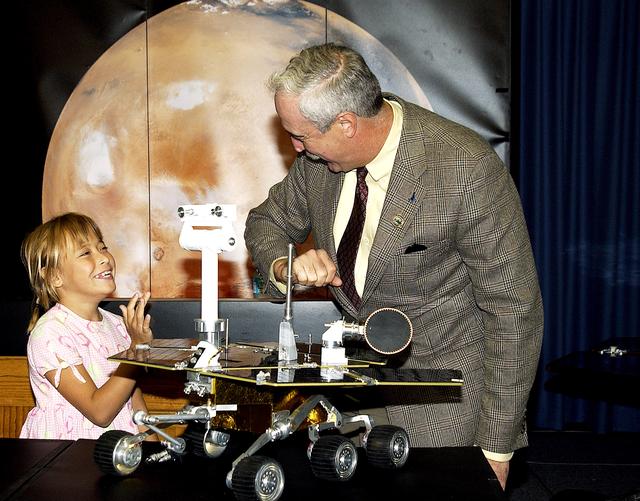 NASA image: KENNEDY SPACE CENTER, FLA. -  Nine-year-old Sofi Collis (left) shares a light moment with NASA Administrator Sean O'Keefe at a press conference.   The Siberian-born Arizona resident wrote the winning entry in the Name the Rovers Contest sponsored by NASA and the Lego Co., a Denmark-based toymaker, with collaboration from the Planetary Society, Pasadena, Calif.  The names she selected for the Mars Exploration Rovers are "Spirit" and "Opportunity." The third grader's essay was chosen from more than 10,000 American student entries.  NASA's twin Mars Exploration Rovers are designed to study the history of water on Mars. These robotic geologists are equipped with a robotic arm, a drilling tool, three spectrometers, and four pairs of cameras that allow them to have a human-like, 3D view of the terrain. Each rover could travel as far as 100 meters in one day to act as Mars scientists' eyes and hands, exploring an environment where humans are not yet able to go. MER-A, with the rover Spirit aboard, is scheduled to launch on June 8 at 2:06 p.m. EDT, with two launch opportunities each day during a launch period that closes on June 24.