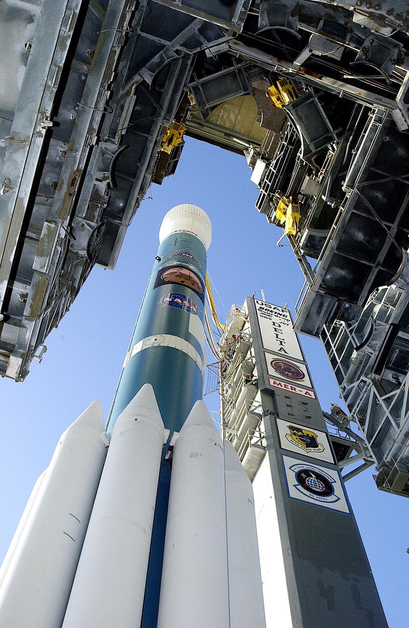 KENNEDY SPACE CENTER, FLA. -   The Boeing Delta II rocket and its Mars Exploration Rover (MER-A) payload is viewed from under the launch tower as it moves away on Launch Complex 17-A, Cape Canaveral Air Force Station.  This will be a second attempt at launch.  The first attempt on June 8, 2003, was scrubbed due to bad weather in the vicinity.  MER-A is the first of two rovers being launched to Mars.  When the two rovers arrive at Mars in 2004, they will bounce to airbag-cushioned landings at sites offering a balance of favorable conditions for safe landings and interesting science. The rovers see sharper images, can explore farther and examine rocks better than anything that has ever landed on Mars.  The designated site for MER-A mission is Gusev Crater, which appears to have been a crater lake.  The second rover, MER-B, is scheduled to launch June 25.
