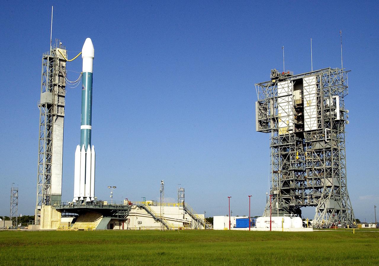KENNEDY SPACE CENTER, FLA. -    The launch tower (right) on Launch Complex 17-A, Cape Canaveral Air Force Station, has been rolled back from the Boeing Delta II rocket and its Mars Exploration Rover (MER-A) payload (left) in preparation for a second attempt at launch.  The first attempt on June 8, 2003, was scrubbed due to bad weather in the vicinity.  MER-A is the first of two rovers being launched to Mars.  When the two rovers arrive at Mars in 2004, they will bounce to airbag-cushioned landings at sites offering a balance of favorable conditions for safe landings and interesting science. The rovers see sharper images, can explore farther and examine rocks better than anything that has ever landed on Mars.  The designated site for MER-A mission is Gusev Crater, which appears to have been a crater lake.  The second rover, MER-B, is scheduled to launch June 25.