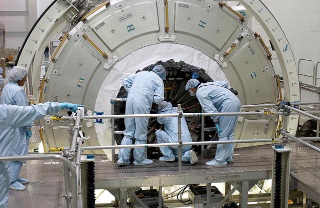 KENNEDY SPACE CENTER, FLA. -  Workers in the Space Station Processing Facility attempt to open the hatch on the Italian-built Node 2, a future element of the International Space Station.  Node 2 arrived at KSC June 1.  The second of three Station connecting modules, the module  attaches to the end of the U.S. Lab and provides attach locations for the Japanese laboratory, European laboratory, the Centrifuge Accommodation Module and, later, Multipurpose Logistics Modules. It will provide the primary docking location for the Shuttle when a pressurized mating adapter is attached to Node 2.  Installation of the module will complete  the U.S. Core of the ISS.  Node 2 is the designated payload for mission STS-120.  No orbiter or launch date has been determined yet.