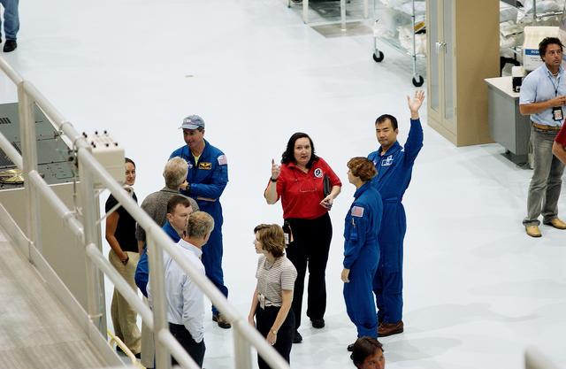 NASA image: KENNEDY SPACE CENTER, FLA. -    Members of the STS-114 crew take a look at the Japanese Experiment Module (JEM) pressure module in the Space Station Processing Facility.  A research laboratory, the pressurized module is the first element of the JEM, named "Kibo" (Hope), to be delivered to KSC.   The National Space Development Agency of Japan (NASDA) developed the laboratory at the Tsukuba Space Center near Tokyo and is Japan's primary contribution to the Station. The JEM also includes an exposed facility (platform) for space environment experiments, a robotic manipulator system, and two logistics modules. The various JEM components will be  assembled in space over the course of three Shuttle missions.