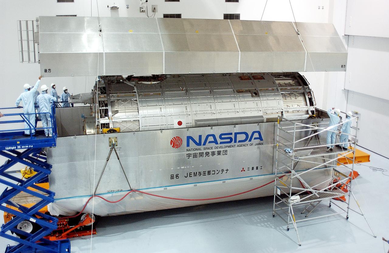 KENNEDY SPACE CENTER, FLA. -   In the Space Station Processing Facility, the lid is removed from the container with the Japanese Experiment Module (JEM) pressure module inside.  A research laboratory, the pressurized module is the first element of the JEM, named "Kibo" (Hope), to be delivered to KSC.   The National Space Development Agency of Japan (NASDA) developed the laboratory at the Tsukuba Space Center near Tokyo and is Japan's primary contribution to the Station. It will enhance the unique research capabilities of the orbiting complex by providing an additional environment for astronauts to conduct science experiments.  The JEM also includes an exposed facility (platform) for space environment experiments, a robotic manipulator system, and two logistics modules. The various JEM components will be  assembled in space over the course of three Shuttle missions.