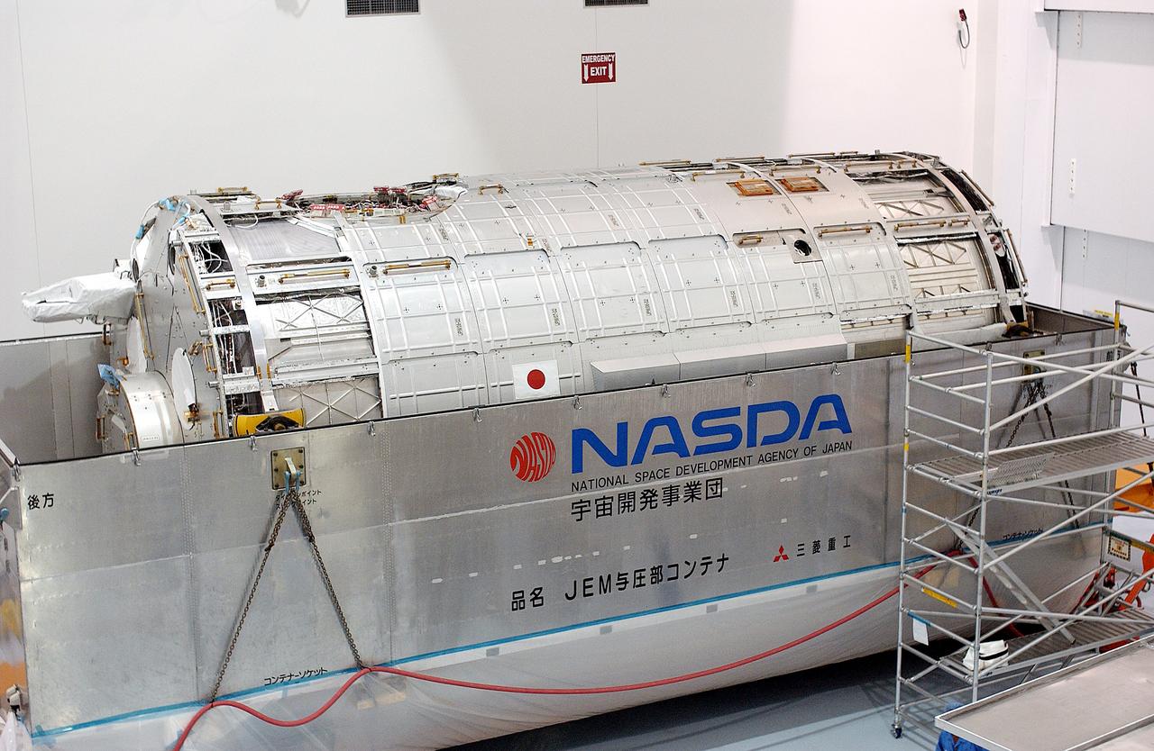 KENNEDY SPACE CENTER, FLA. -  In the Space Station Processing Facility, the Japanese Experiment Module (JEM) pressure module is exposed after removal of the lid of its shipping container.  A research laboratory, the pressurized module is the first element of the JEM, named "Kibo" (Hope), to be delivered to KSC.   The National Space Development Agency of Japan (NASDA) developed the laboratory at the Tsukuba Space Center near Tokyo and is Japan's primary contribution to the Station. It will enhance the unique research capabilities of the orbiting complex by providing an additional environment for astronauts to conduct science experiments.  The JEM also includes an exposed facility (platform) for space environment experiments, a robotic manipulator system, and two logistics modules. The various JEM components will be  assembled in space over the course of three Shuttle missions.
