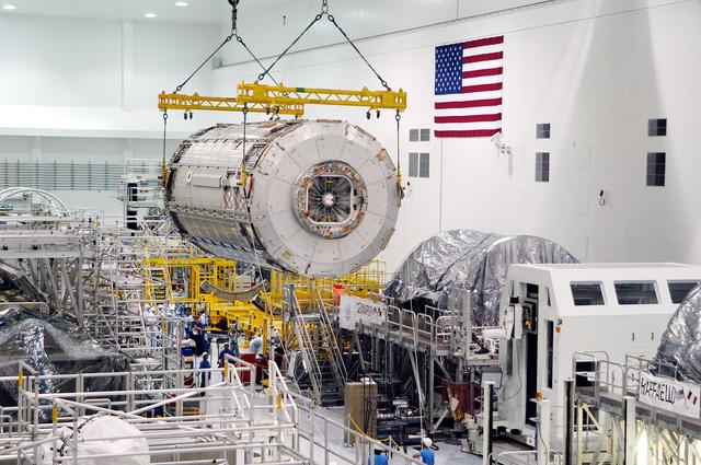 NASA image: KENNEDY SPACE CENTER, FLA. -  The Japanese Experiment Module (JEM) pressure module is moved past other ISS elements in the Space Station Processing Facility to a work stand.  A research laboratory, the pressurized module is the first element of the JEM, named "Kibo" (Hope), to be delivered to KSC.   The National Space Development Agency of Japan (NASDA) developed the laboratory at the Tsukuba Space Center near Tokyo and is Japan's primary contribution to the Station. It will enhance the unique research capabilities of the orbiting complex by providing an additional environment for astronauts to conduct science experiments.  The JEM also includes an exposed facility (platform) for space environment experiments, a robotic manipulator system, and two logistics modules. The various JEM components will be  assembled in space over the course of three Shuttle missions.