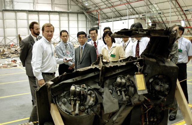 NASA image: KENNEDY SPACE CENTER, FLA. -  Shuttle Launch Director Mike Leinbach (second from left) accompanies Executive Director of NASDA Koji Yamamoto (fourth from left) and others visiting the Columbia Debris Hangar.  Mr. Yamamoto is at KSC for a welcome ceremony involving the arrival of the newest Space Station module, the Japanese Experiment Module/pressurized module.
