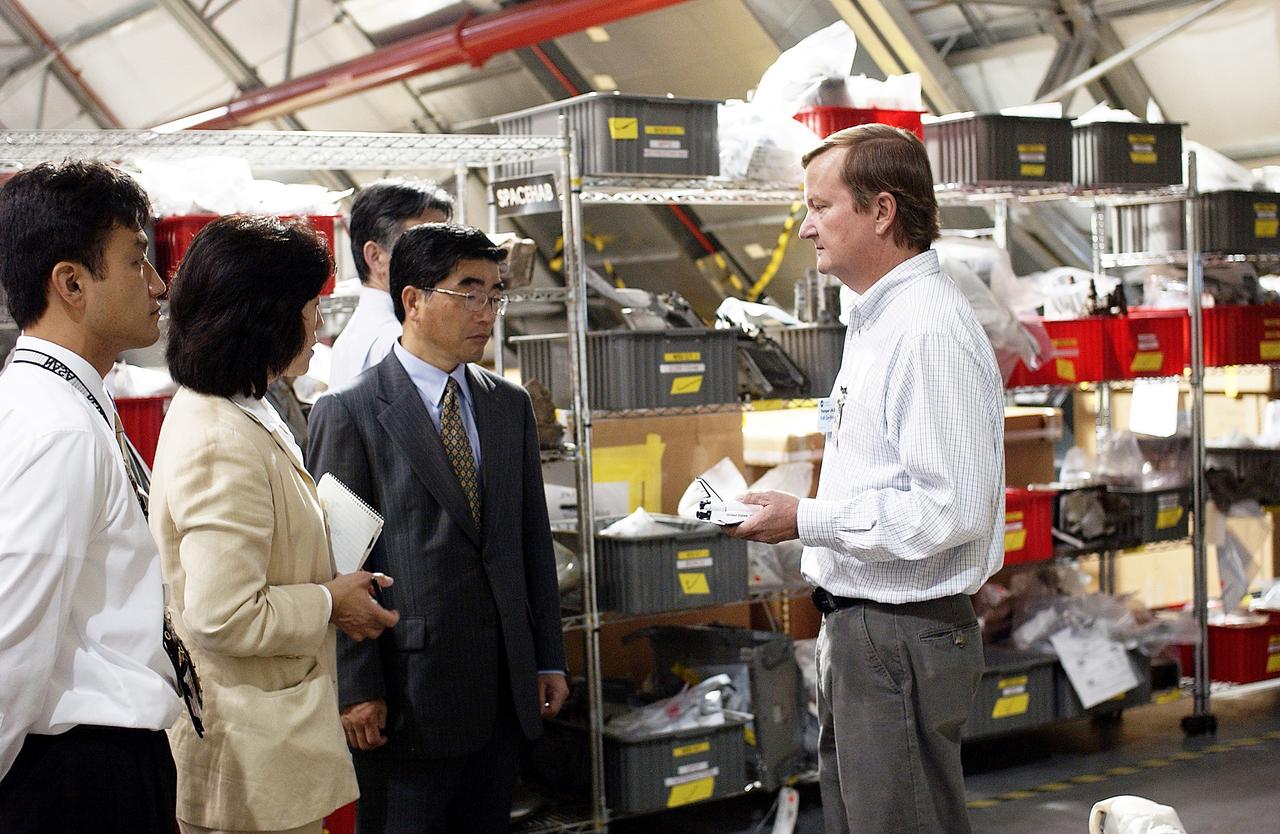 KENNEDY SPACE CENTER, FLA. -  Shuttle Launch Director Mike Leinbach (right) explains recovery and reconstruction efforts of Columbia to the Executive Director of NASDA Koji Yamamoto (third from left) and others visiting the Columbia Debris Hangar.   Mr. Yamamoto is at KSC for a welcome ceremony involving the arrival of the newest Space Station module, the Japanese Experiment Module/pressurized module.