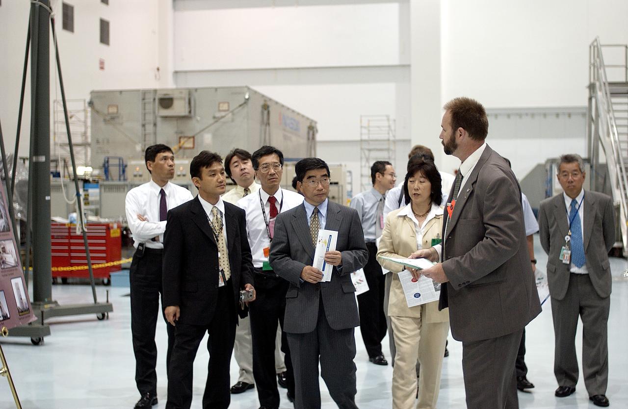 KENNEDY SPACE CENTER, FLA. - In the Space Station Processing Facility, Executive Director of NASDA Koji Yamamoto (center) joins others for a tour. Mr. Yamamoto is at KSC for a welcome ceremony involving the arrival of the newest Space Station module, the Japanese Experiment Module/pressurized module.