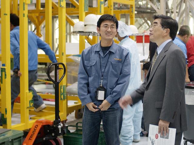 NASA image: KENNEDY SPACE CENTER, FLA. -  In the Space Station Processing Facility, Executive Director of NASDA Koji Yamamoto (right) looks at the newly arrived Japanese Experiment Module (JEM)/pressurized module.  Mr. Yamamoto is at KSC for a welcome ceremony involving the arrival of JEM.