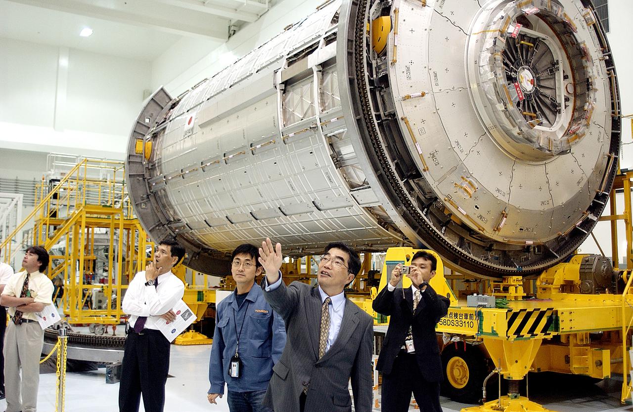 KENNEDY SPACE CENTER, FLA. -  In the Space Station Processing Facility, Executive Director of NASDA Koji Yamamoto points to other Space Station elements.  Behind him is the Japanese Experiment Module (JEM)/pressurized module.  Mr. Yamamoto is at KSC for a welcome ceremony involving the arrival of JEM.