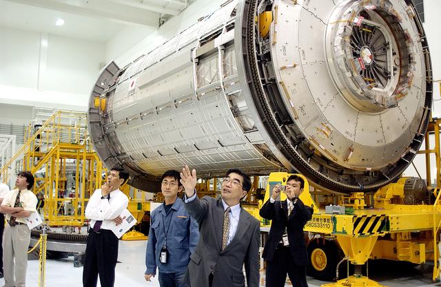NASA image: KENNEDY SPACE CENTER, FLA. -  In the Space Station Processing Facility, Executive Director of NASDA Koji Yamamoto points to other Space Station elements.  Behind him is the Japanese Experiment Module (JEM)/pressurized module.  Mr. Yamamoto is at KSC for a welcome ceremony involving the arrival of JEM.