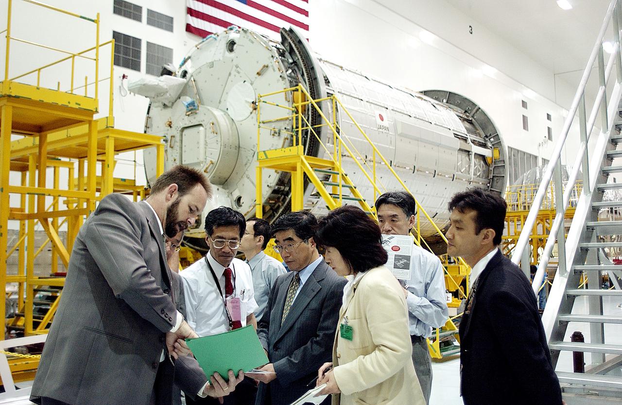 KENNEDY SPACE CENTER, FLA. -  In the Space Station Processing Facility, Executive Director of NASDA Koji Yamamoto (center) gets information about the facility while on a tour of KSC.  Behind the group is the Japanese Experiment Module (JEM)/pressurized module.  Mr. Yamamoto is at KSC for a welcome ceremony involving the arrival of JEM.