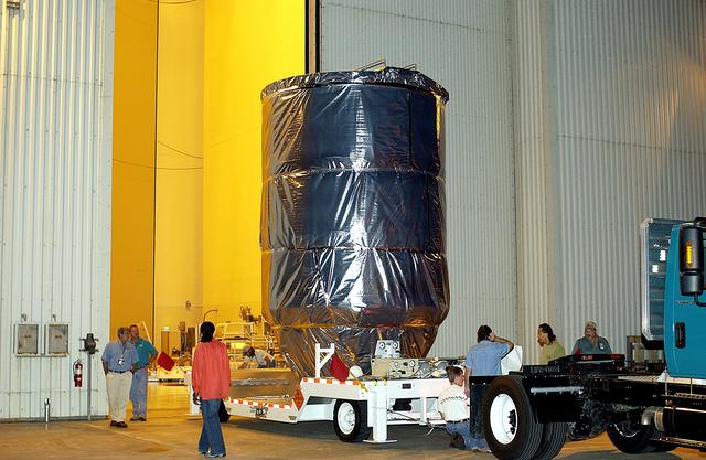 NASA image: KENNEDY SPACE CENTER, FLA. -  The Mars Exploration Rover 1 (MER-B) is moved  out of the Payload Hazardous Servicing Facility for transfer to Launch Pad 17-B, Cape Canaveral Air Force Station.  The second of twin rovers being sent to Mars, it is equipped with a robotic arm, a drilling tool, three spectrometers, and four pairs of cameras that allow it to have a human-like, 3D view of the terrain. Each rover could travel as far as 100 meters in one day to act as Mars scientists' eyes and hands, exploring an environment where humans can't yet go.  MER-B is scheduled to launch June 26 at one of two available times,  12:27:31 a.m. EDT or 1:08:45 a.m. EDT.
